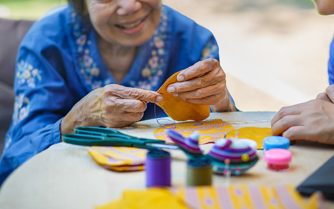 Picture of Asian woman working with materials to improve manual dexterity.