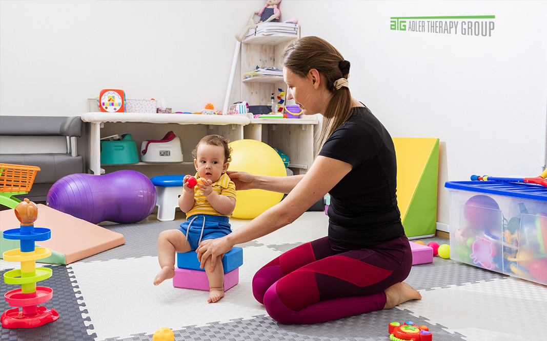 Picture of occupational therapist helping young toddler.