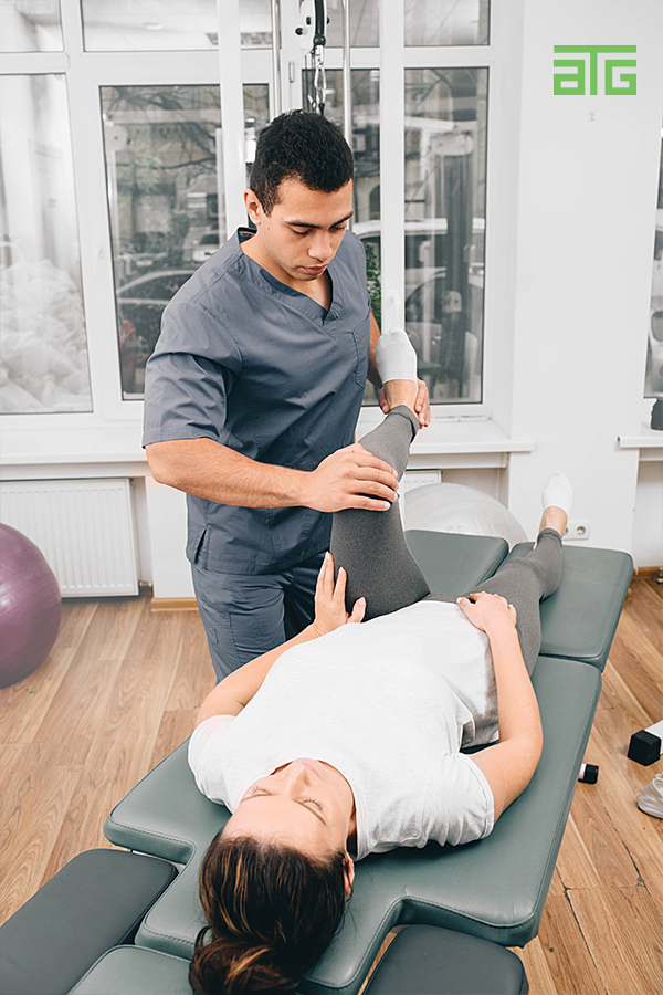 Physical therapist assisting patient with hip pain treatment on therapy table in Chesapeake VA