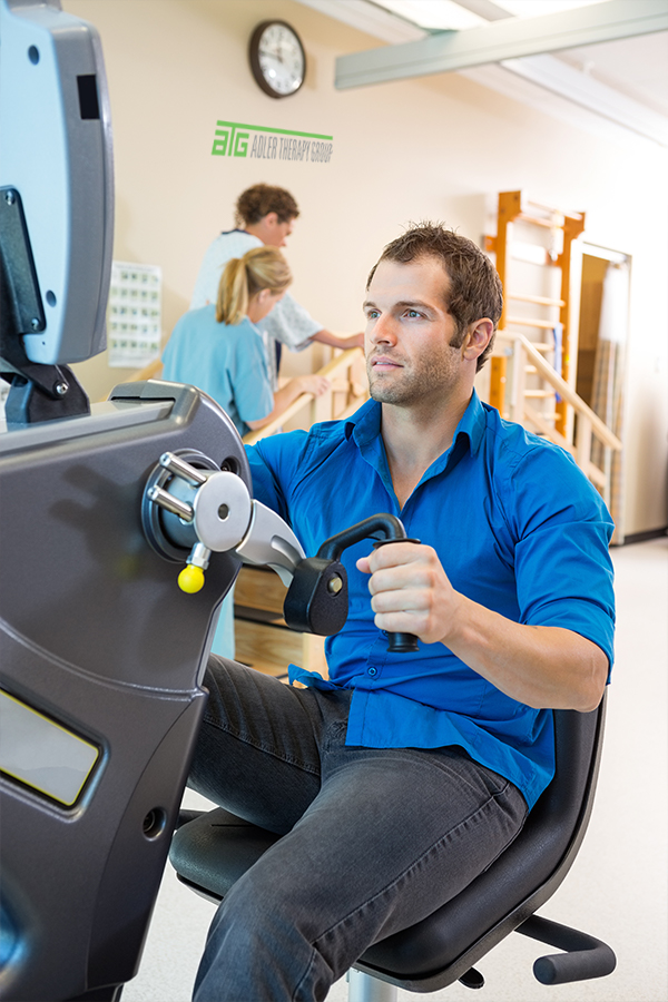 Patient performing upper body strengthening exercise on rehabilitation equipment during post-surgical physical therapy in Chesapeake VA
