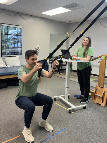 Physical therapist assisting a patient with therapeutic exercises at Adler Therapy Group Virginia Beach Newtown